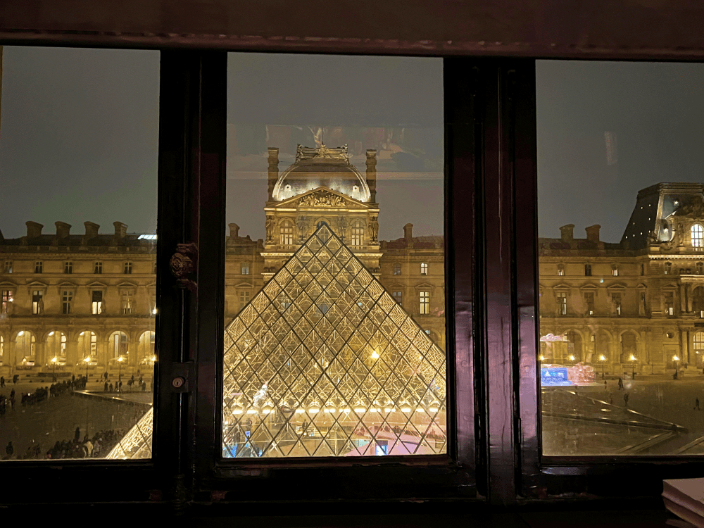 louvre pyramid at night from gift shop view