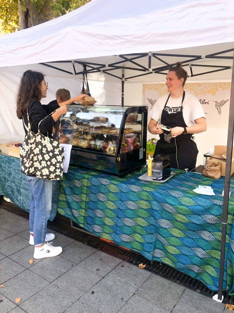 Le Petit Colibri offering vegan cake to customer at vegan place lyon france on place de la republique in 2022