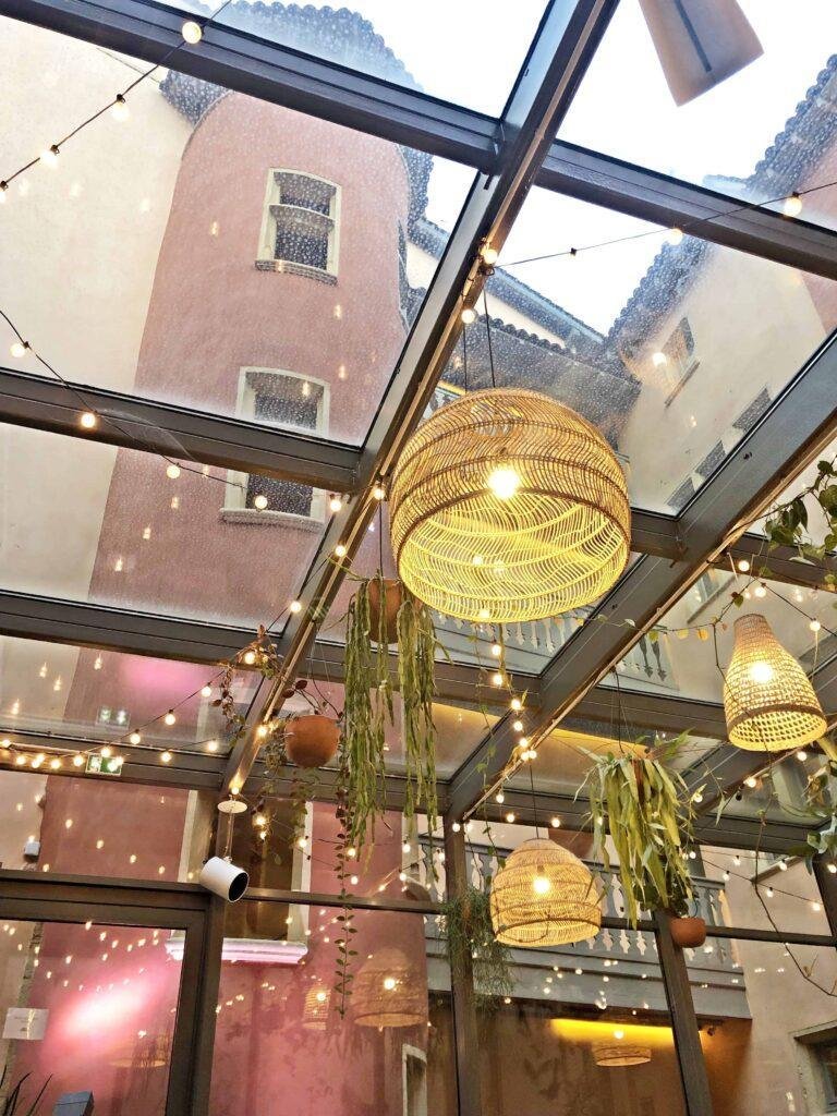 Indoor seating at Food Traboule Restaurant in Lyon with beautiful tour rose in the background